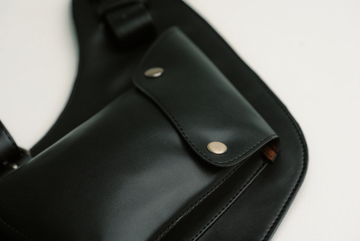 Close-up of Lashasana black cactus leather holster bag showing flap, stitching and metal studs