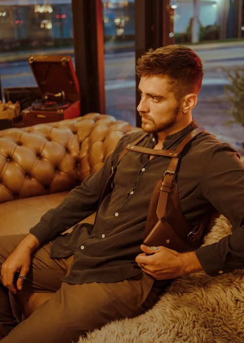 Model seated wearing the Lashasana brown vegan cactus leather holster