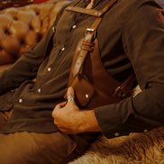 Side angle of model seated wearing the Lashasana brown vegan cactus leather holster