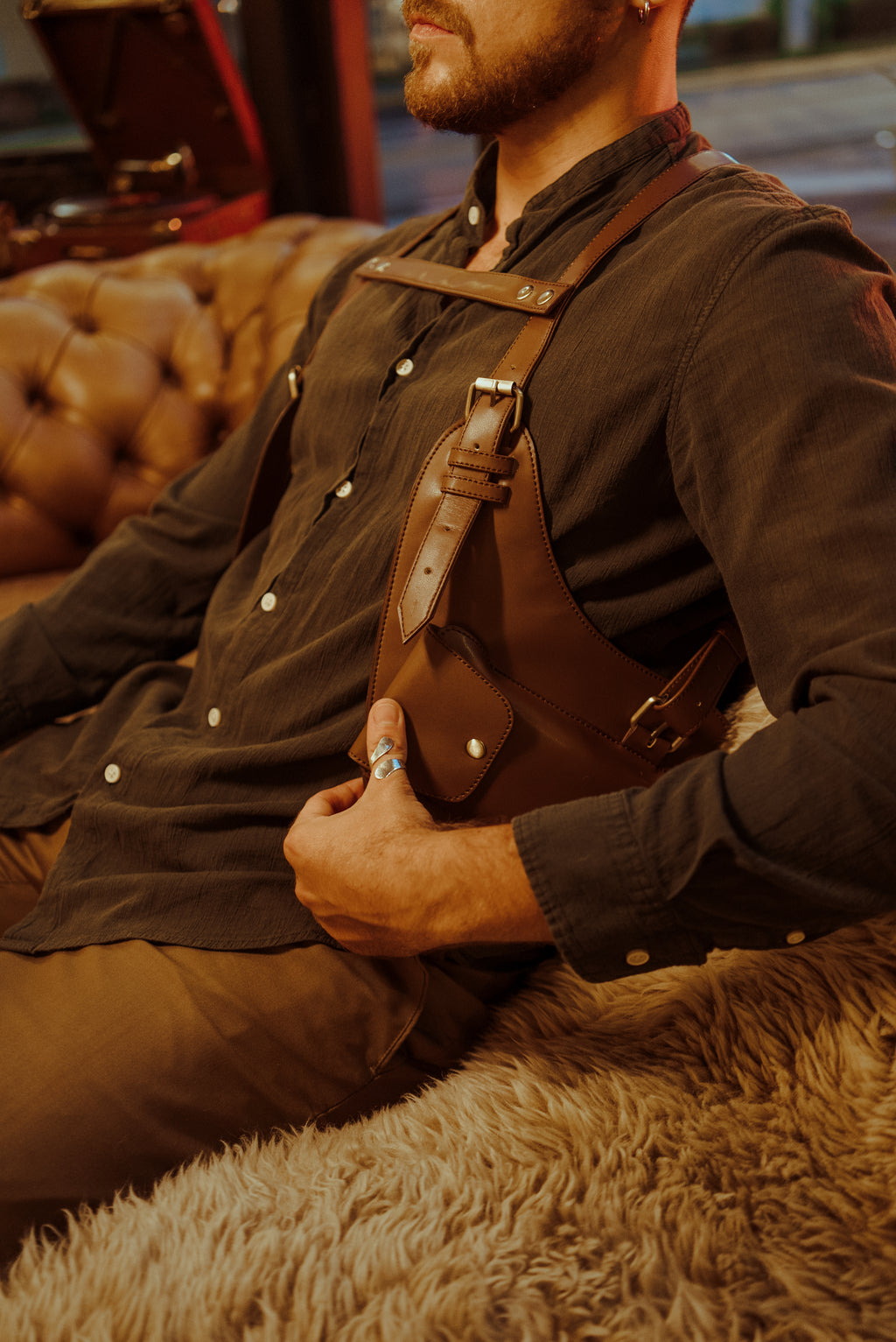 Side angle of model seated wearing the Lashasana brown vegan cactus leather holster