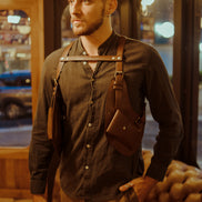 Model seated wearing the Lashasana brown vegan cactus leather holster, alternate pose