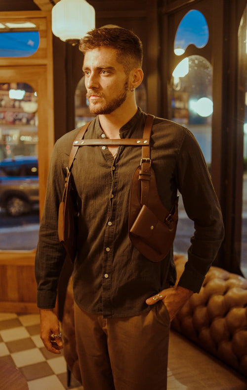 Model seated wearing the Lashasana brown vegan cactus leather holster, alternate pose