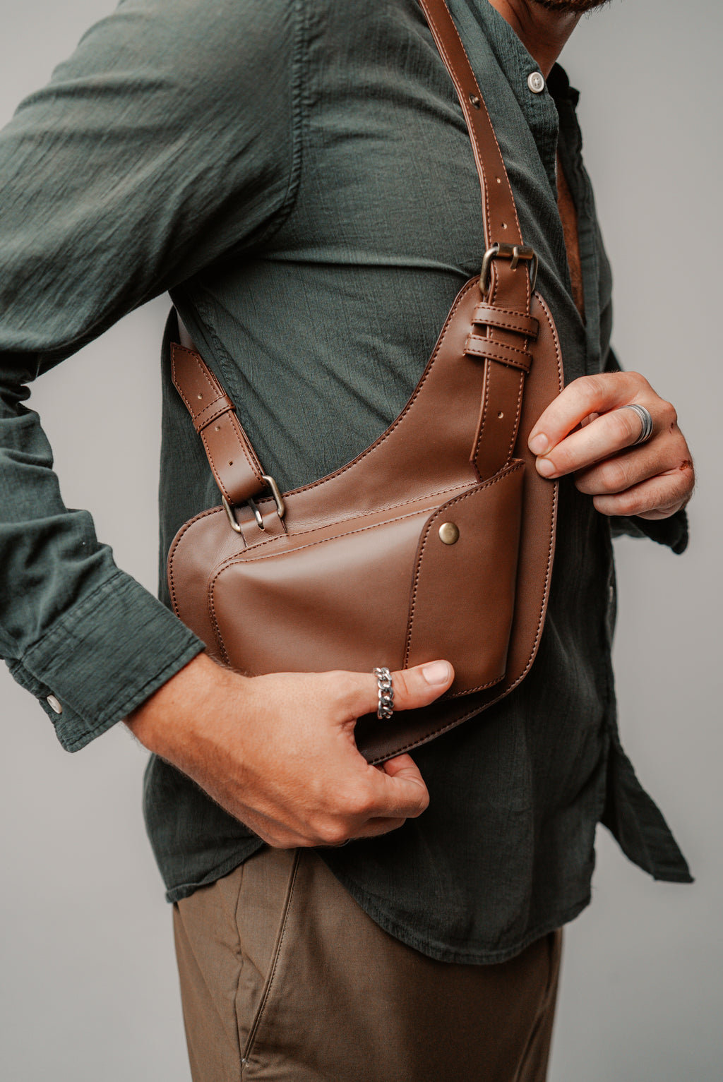Model wearing the Lashasana brown vegan cactus leather holster against a plain background