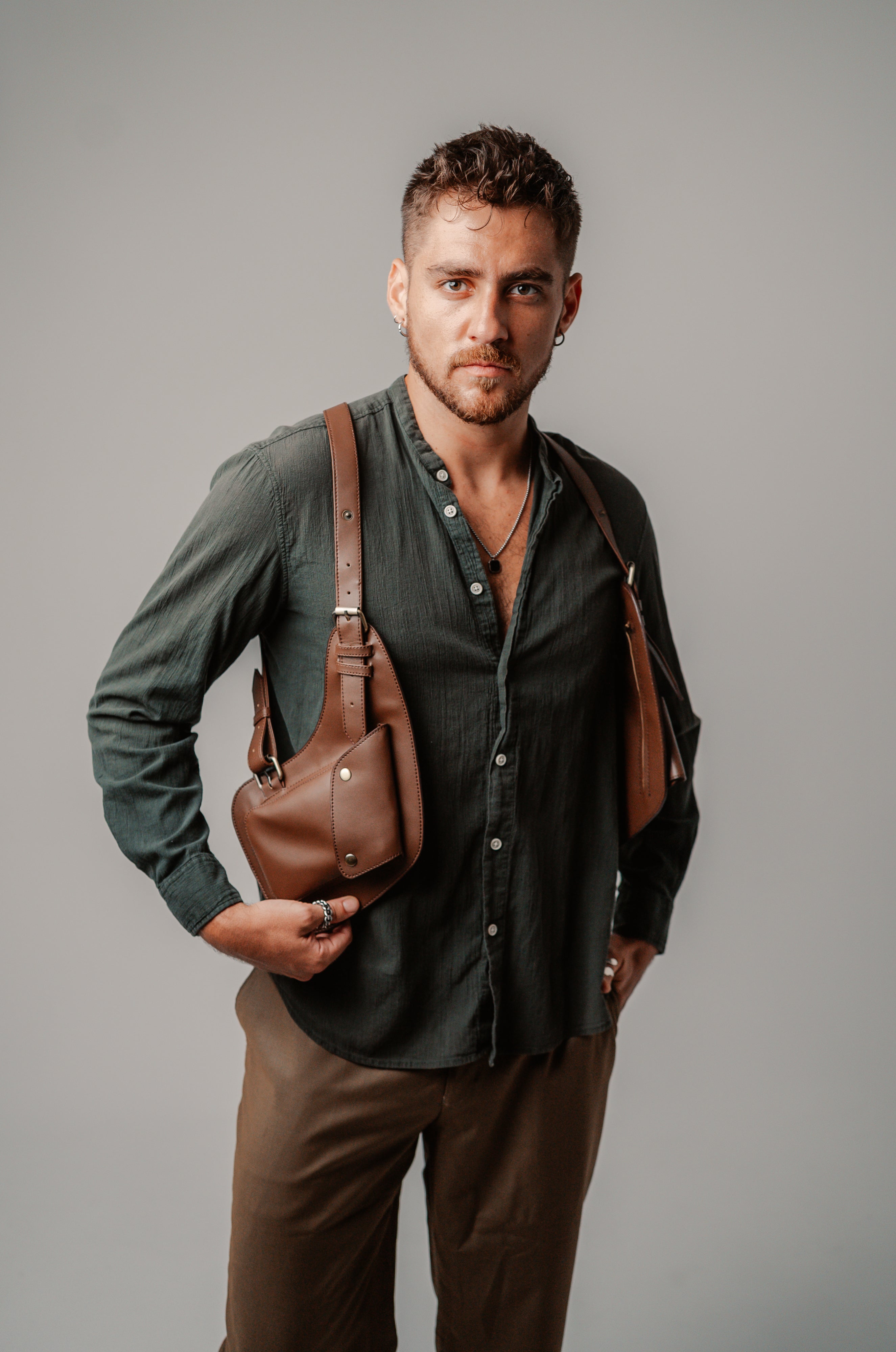 Model holding the Lashasana brown vegan cactus leather holster